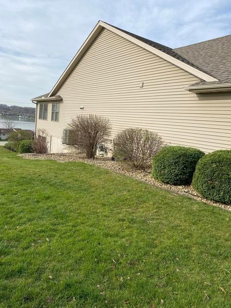 A house with a large lawn in front of it.