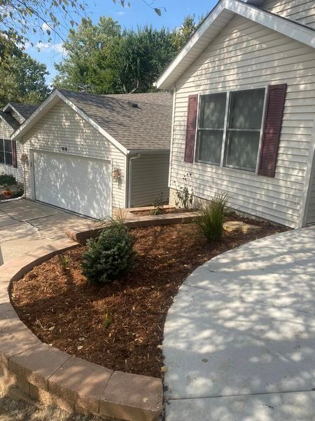 A white house with red shutters and a driveway