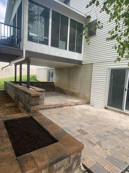 The backyard of a house with a patio and a deck.