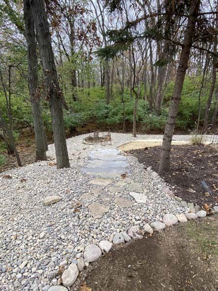 A path surrounded by rocks in the middle of a forest.
