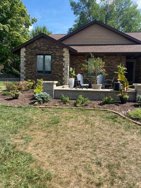 A house with a large lawn in front of it.