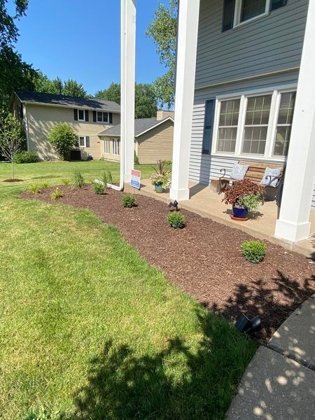 A house with a porch and a lawn in front of it