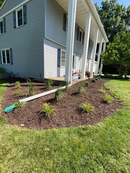 A large house with a lot of mulch in front of it.
