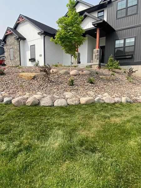 A large house with a lot of rocks in front of it.