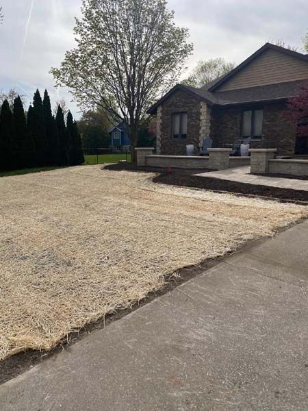 A house with a gravel driveway in front of it.