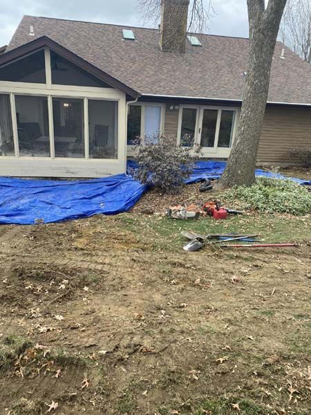 A screened in porch is being built in the backyard of a house.
