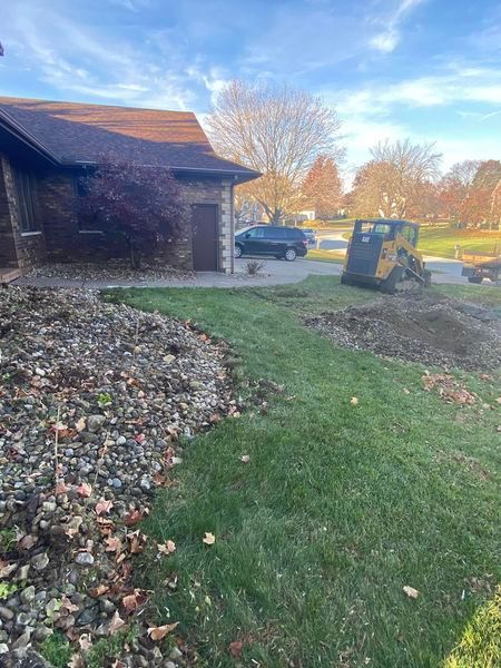 A house with a stump grinder in front of it.