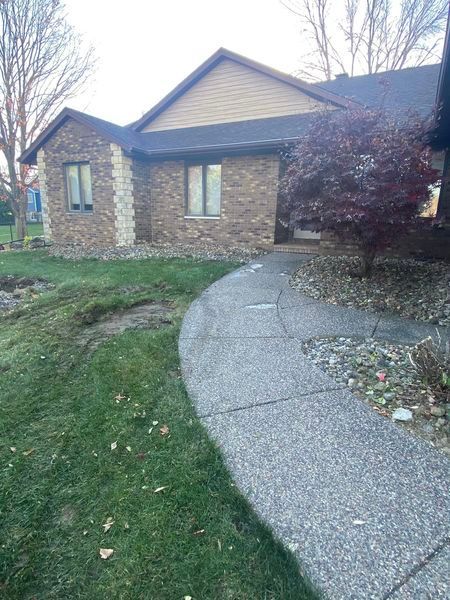 A brick house with a walkway leading to it.