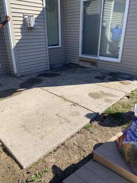 A concrete walkway is being built in front of a house.