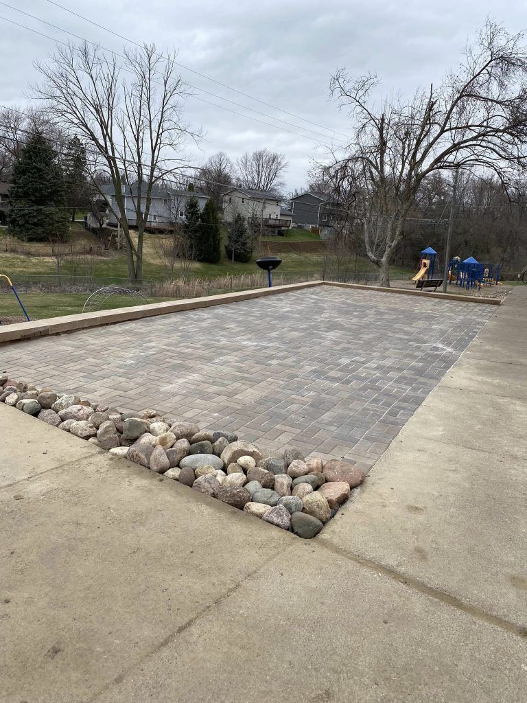 There is a playground in the background and a patio in the foreground.