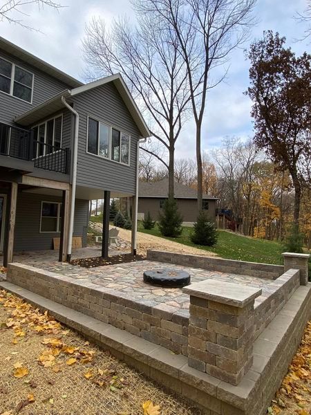 There is a fire pit in the backyard of a house.