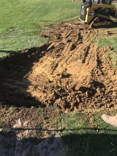 A bulldozer is digging a hole in the ground.