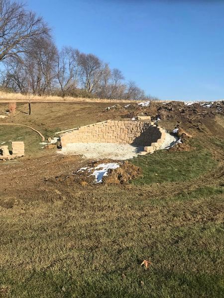 A large pile of dirt is sitting in the middle of a field.