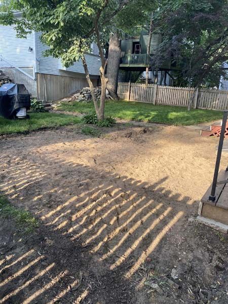There is a lot of dirt in the backyard of a house.