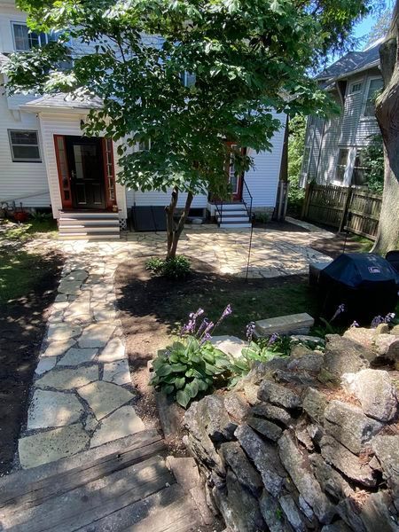 A stone walkway leading to the front door of a house.