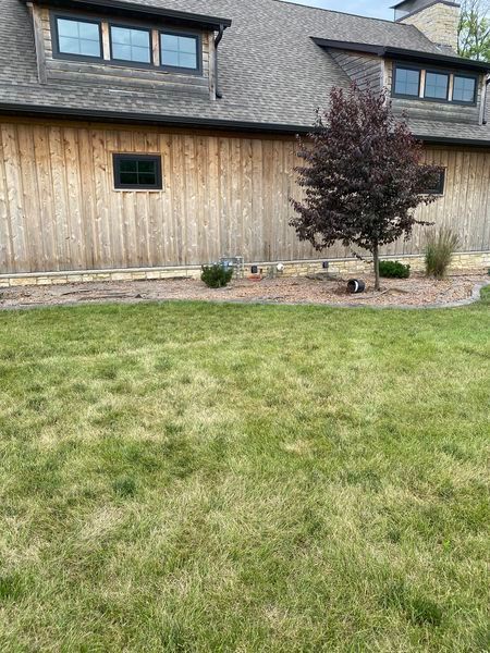 A large house with a large lawn in front of it.