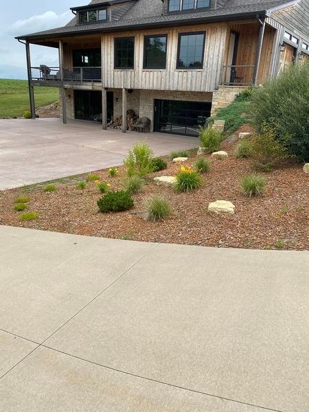 A large house with a lot of windows is sitting on top of a hill.