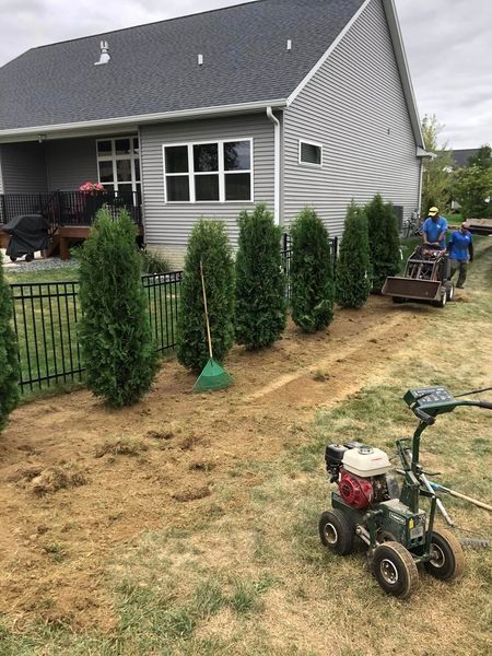 A lawn mower is parked in front of a house.