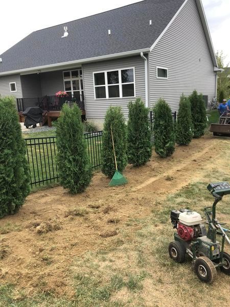 A lawn mower is parked in front of a house.