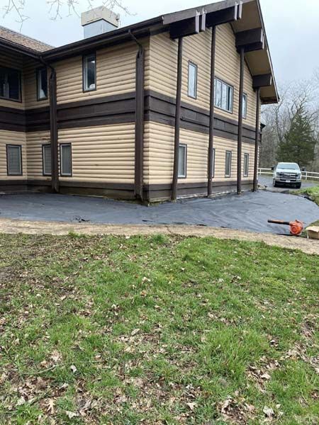 A large building with a lot of windows and a car parked in front of it.