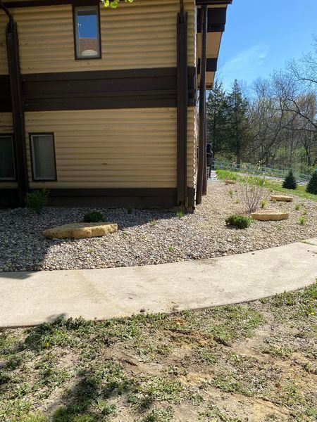 A house with a walkway leading to it and a sidewalk in front of it.