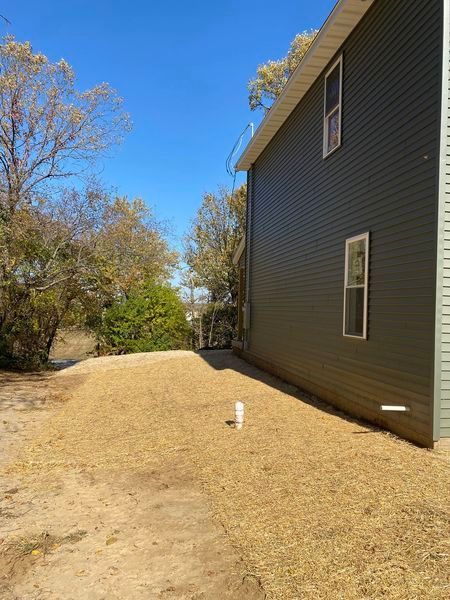 A large house with a lot of windows and a lot of grass in front of it.