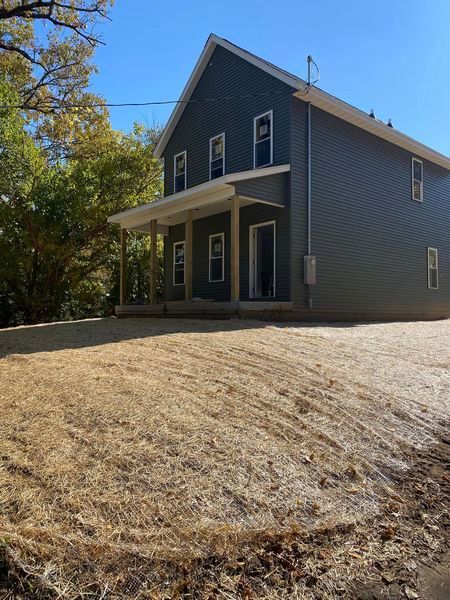A house with a lot of dirt in front of it