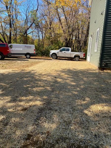 A white truck is parked in front of a house.