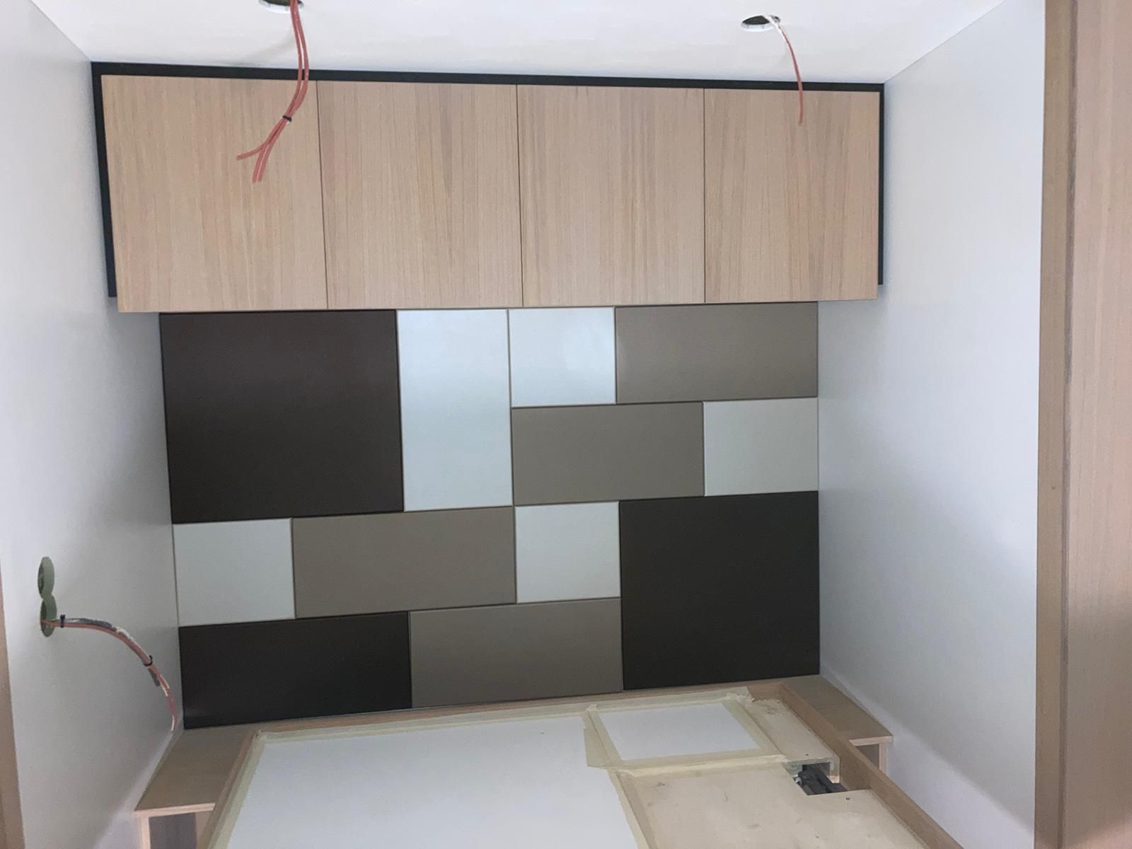 leren achterwand met houten kasten in slaapkamer op een woonwagen