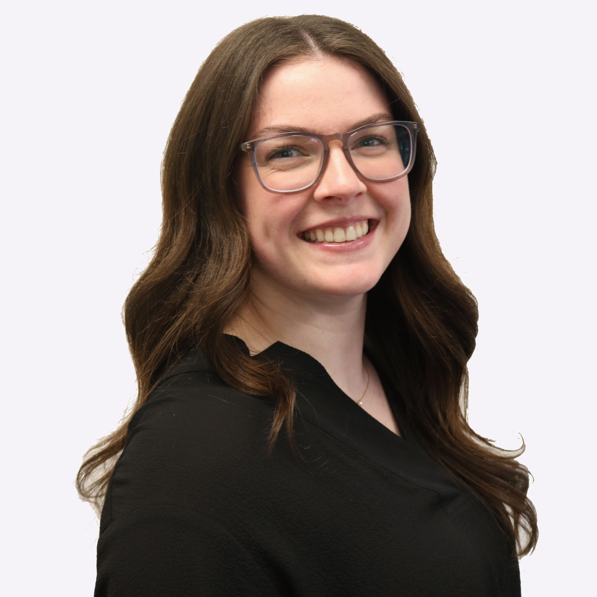A woman with long hair is smiling and wearing a plaid shirt.