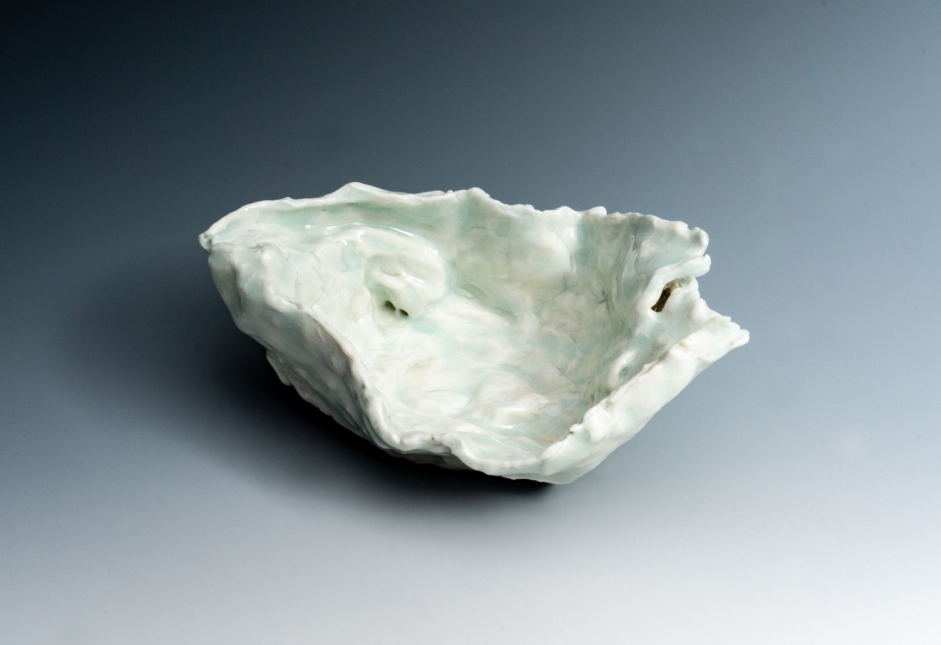 A white object is sitting on a gray surface.