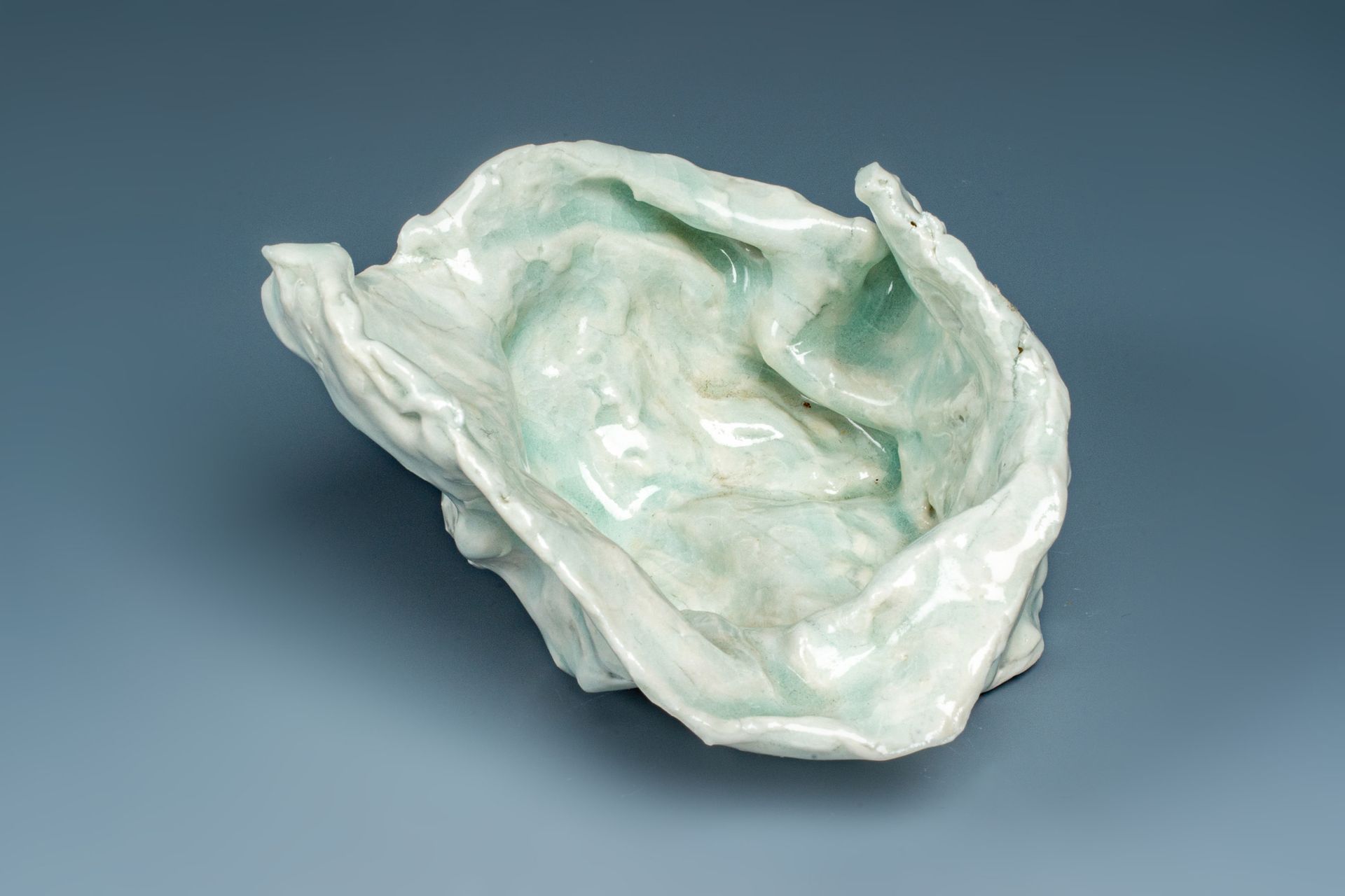 A white object is sitting on a blue surface.