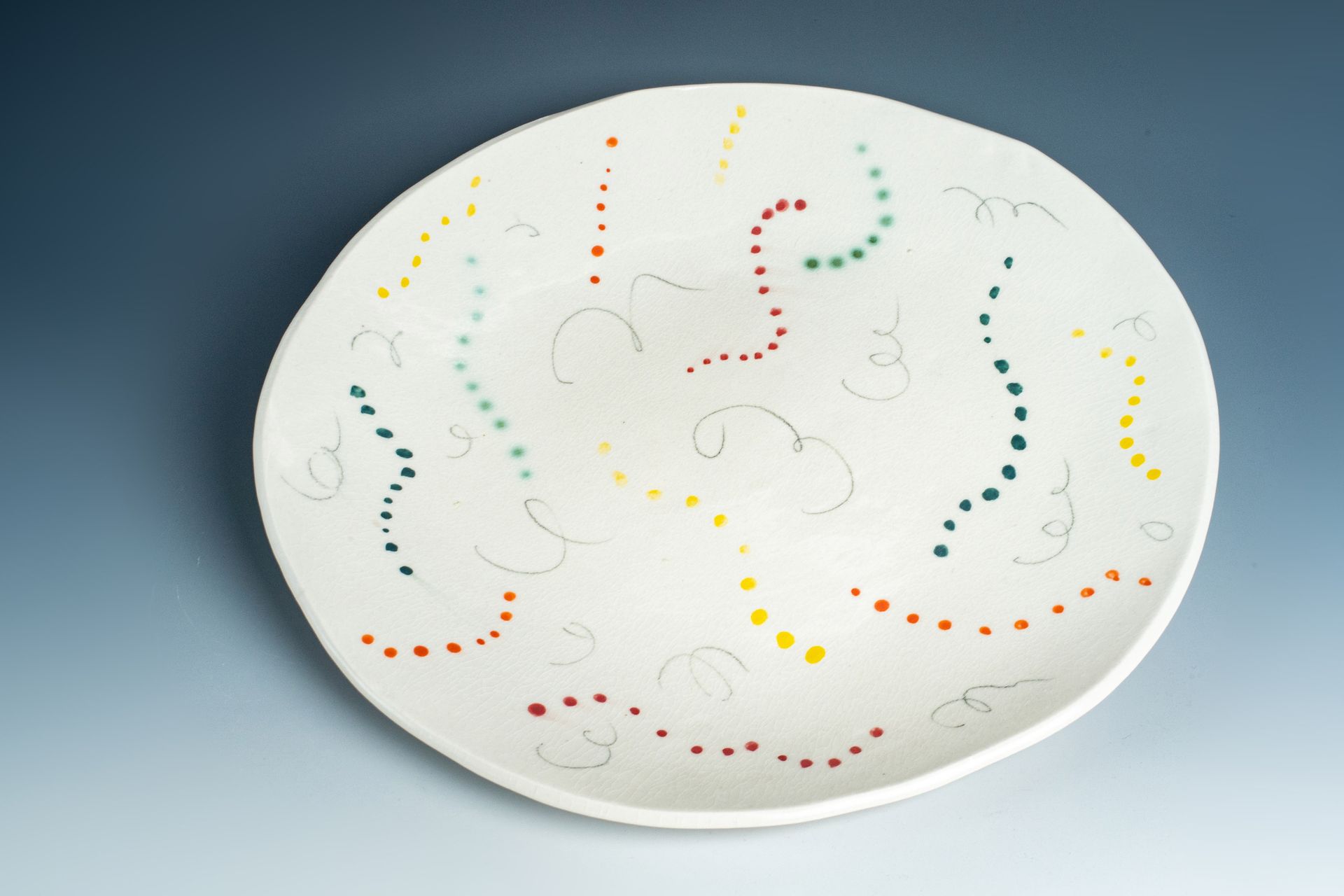 A white plate with colorful swirls on it