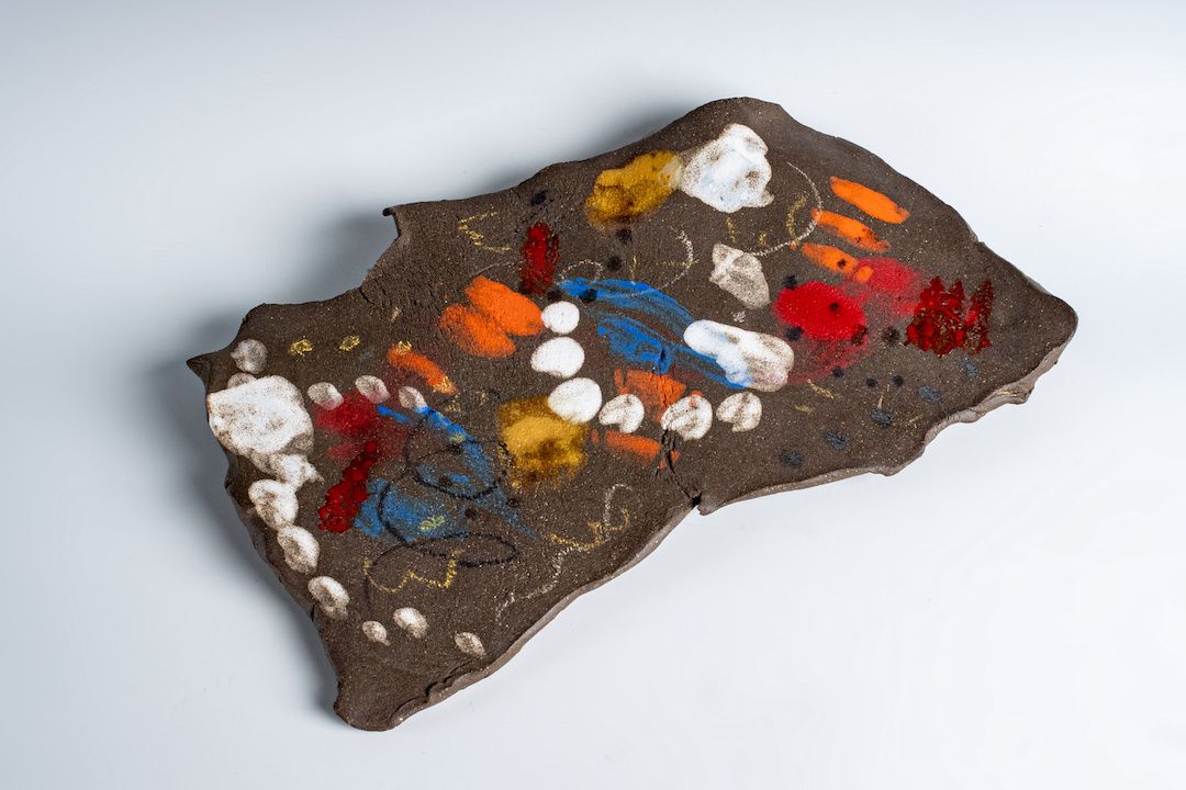 A piece of clay with a lot of colors on it