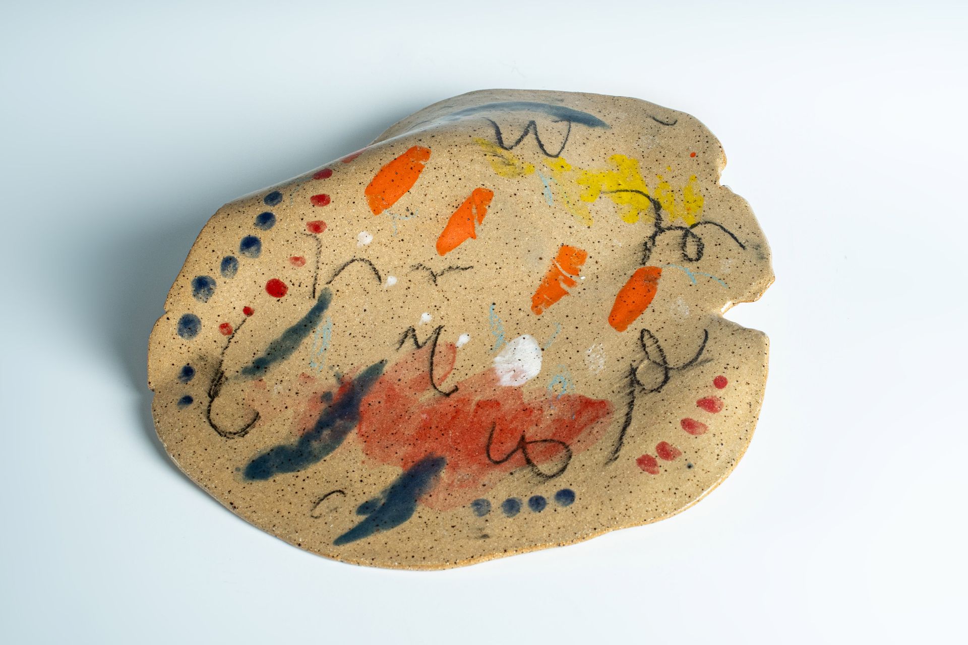 A piece of clay with a colorful design on it