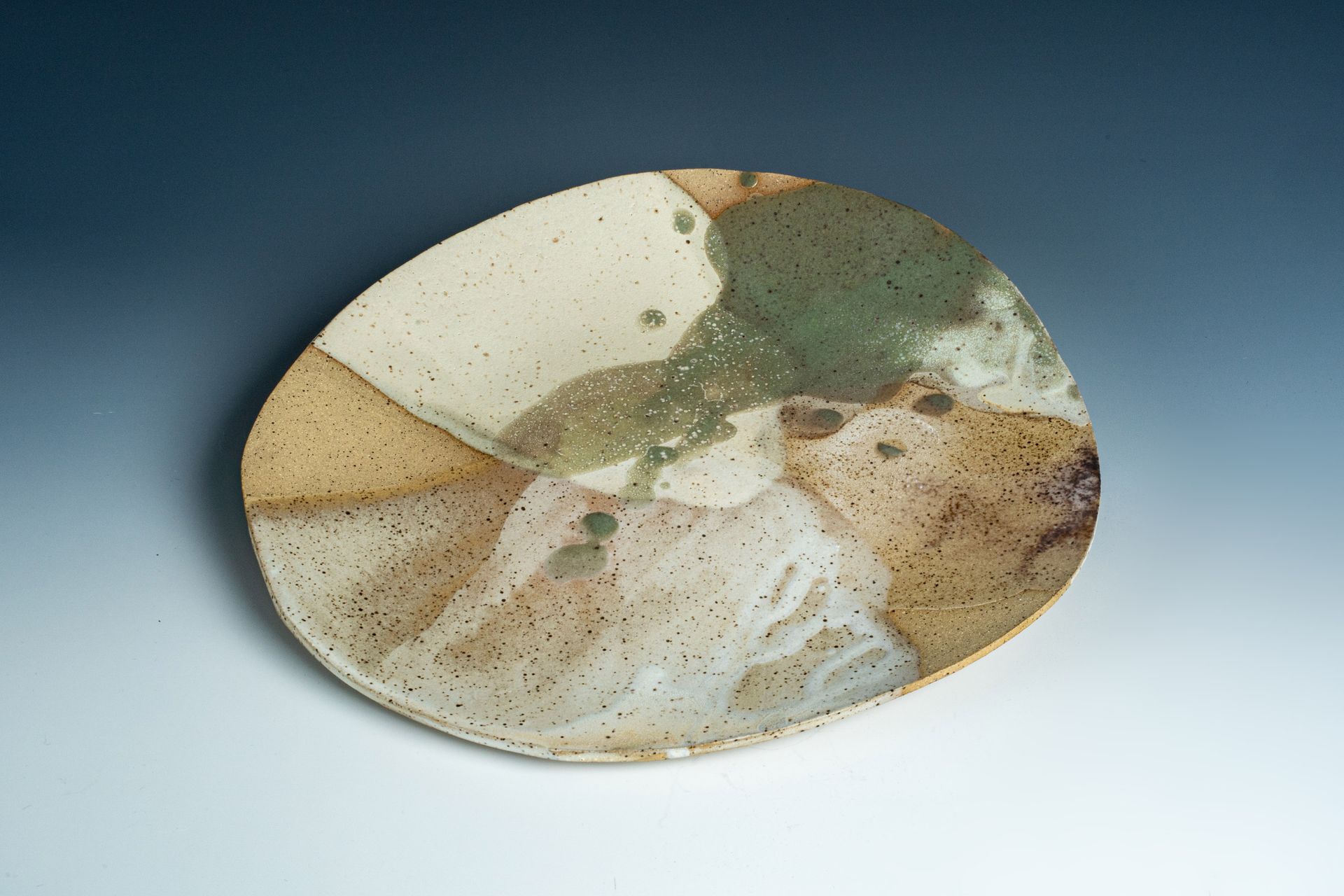 A ceramic plate with a swirl pattern on it