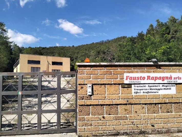 Un muro di mattoni con un cancello e un cartello che dice fausto rapagna