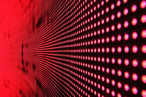 Red LED screen with rows of glowing dots, angled perspective.