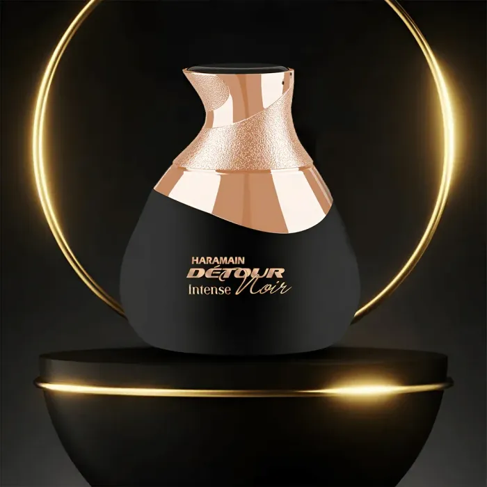 A bottle of detour intense noir perfume on a black podium