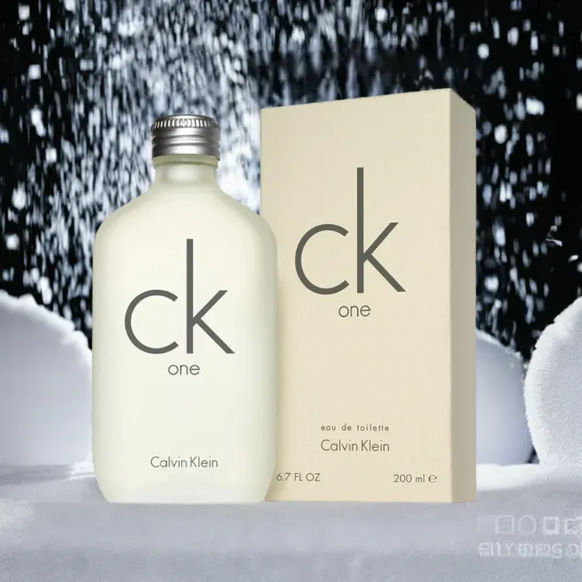 A bottle of ck one perfume next to its box