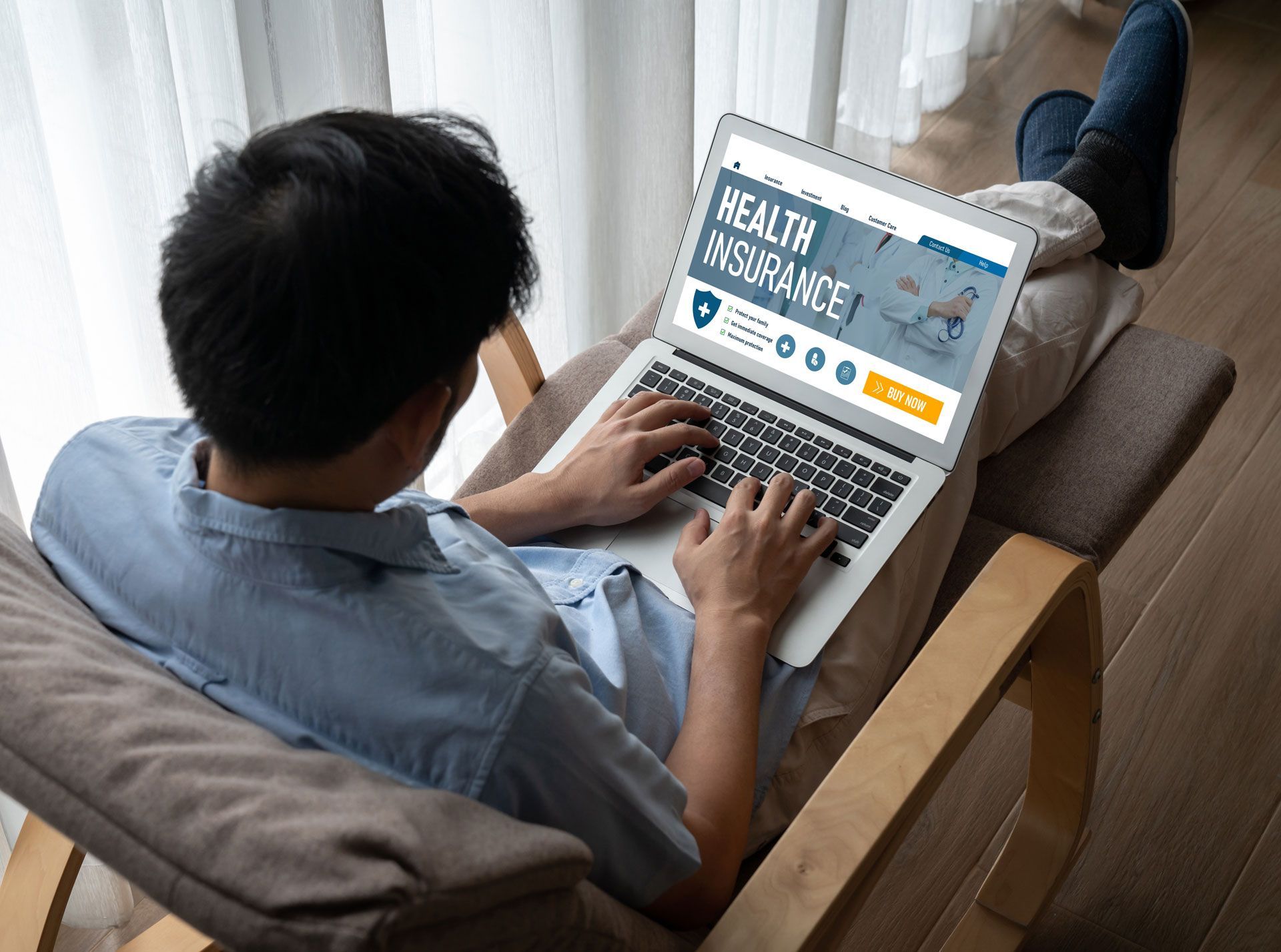 Person reclining in a chair, using a laptop with a 