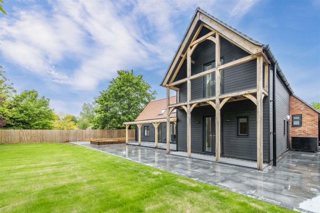A large house with a large lawn in front of it.