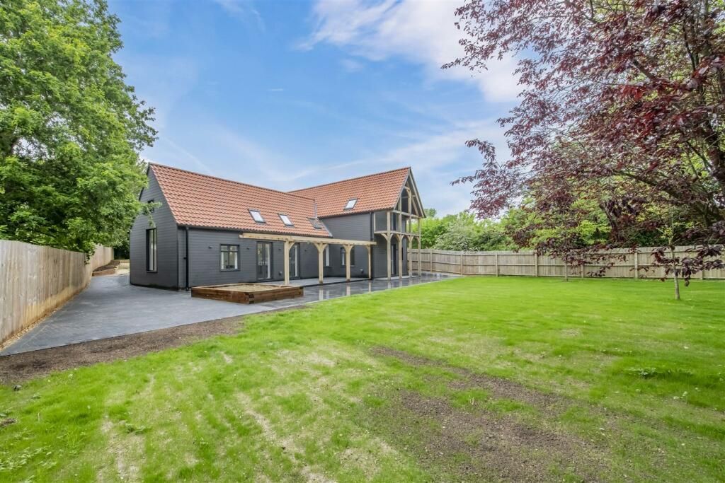 A large house with a large lawn in front of it.