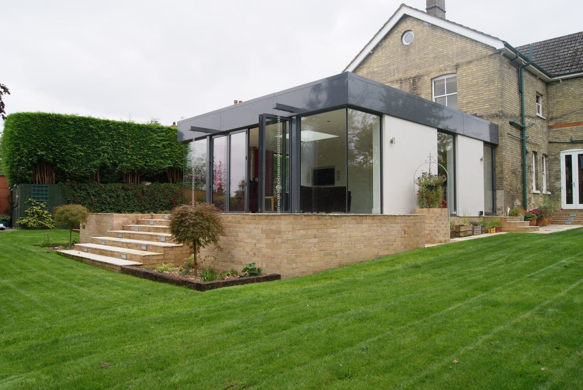 A large house with a large lawn in front of it.