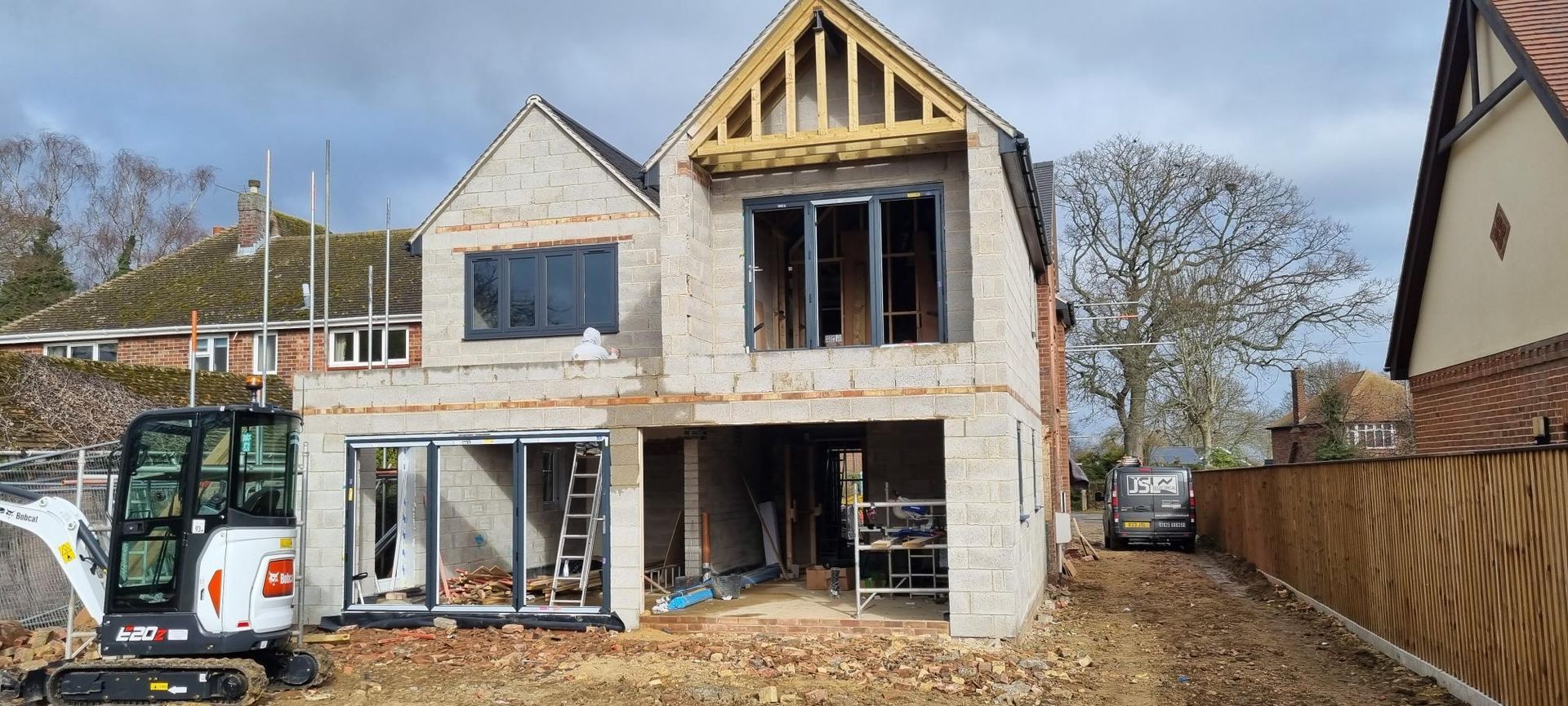 A house is being built in the middle of a dirt field.