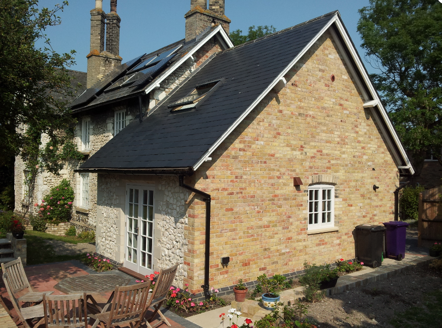 A small brick house with a slate roof