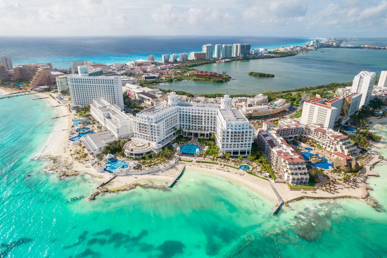 an aerial view of a resort on a small island in the middle of the ocean .