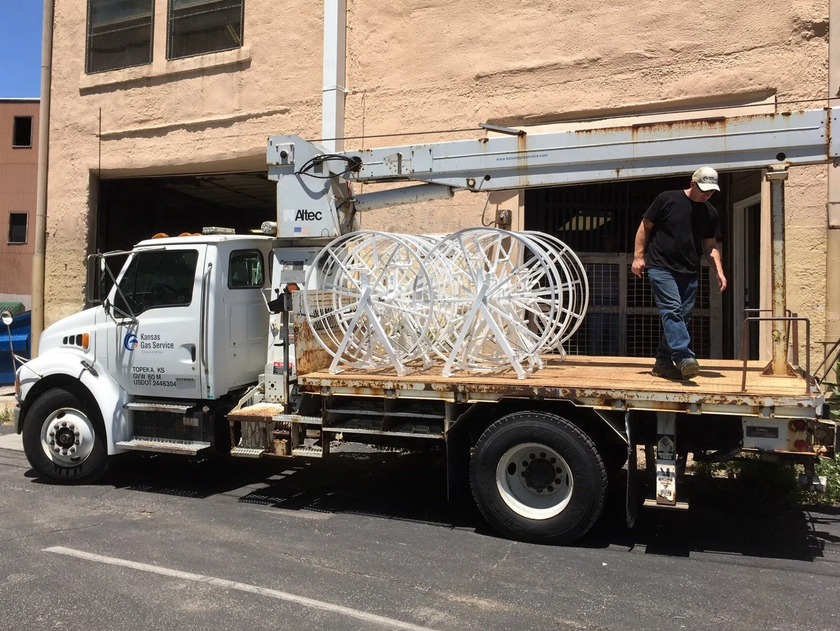 A white truck is parked in front of a building