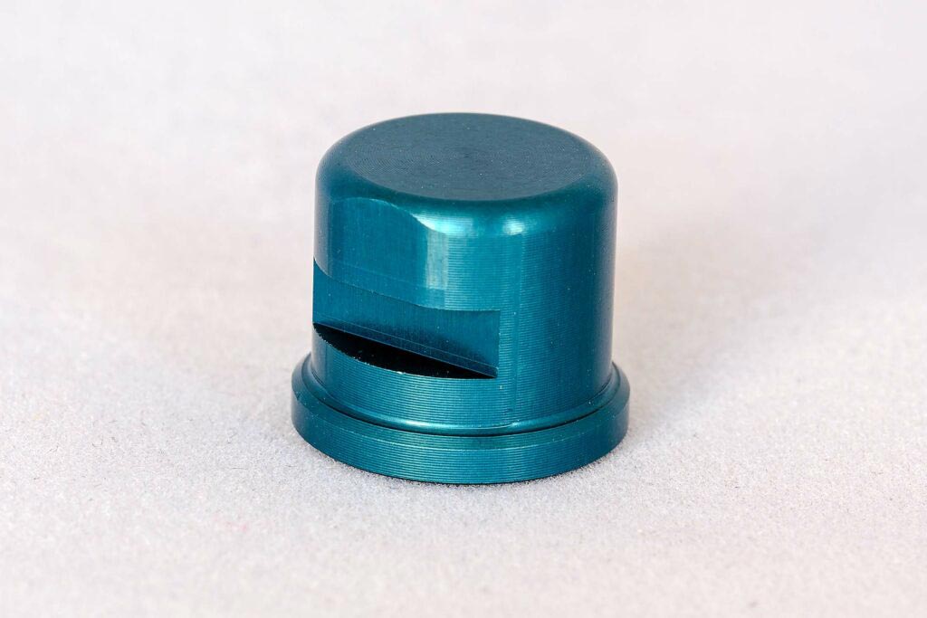 A small blue object is sitting on a white surface.