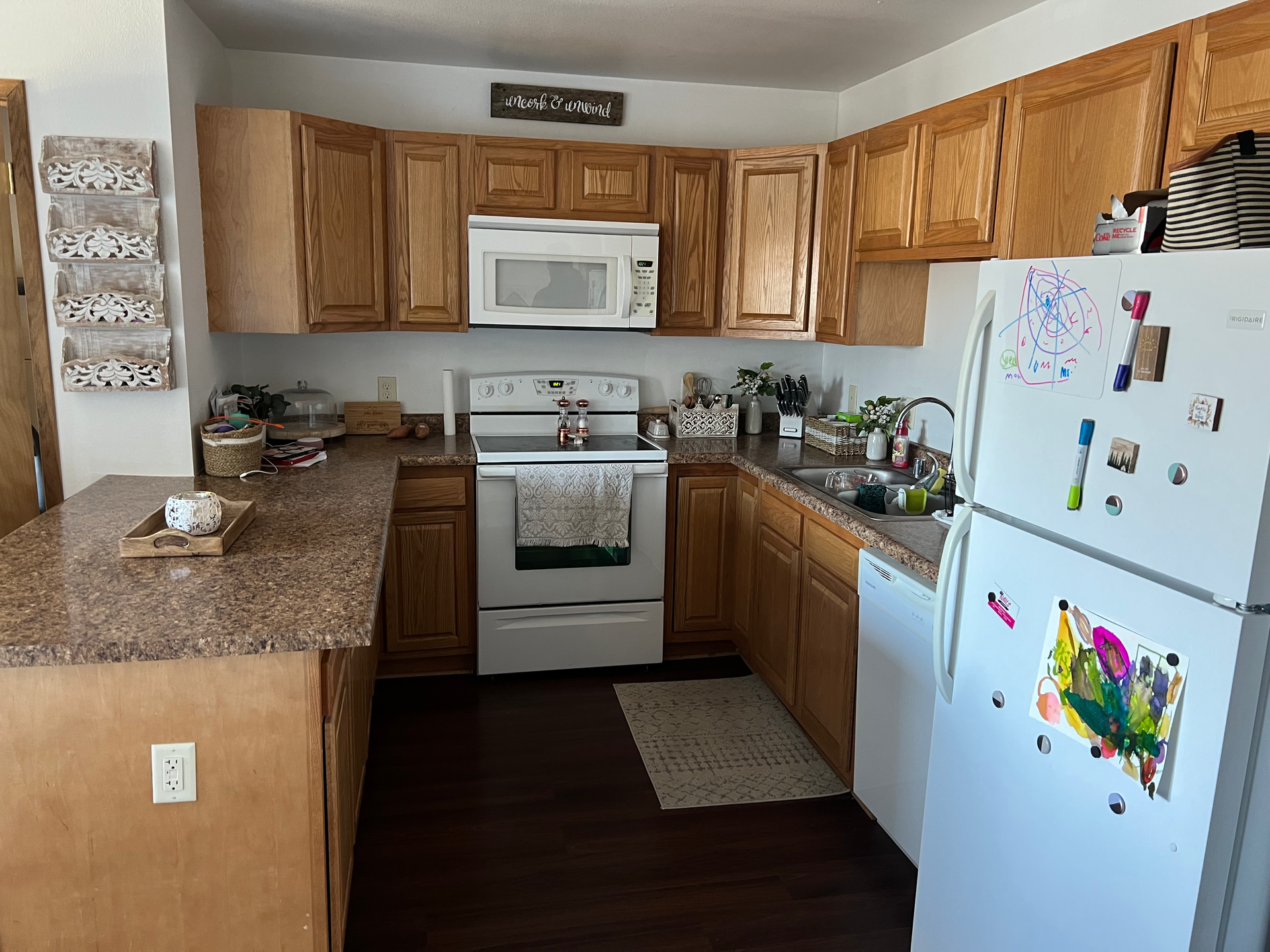 A kitchen with wooden cabinets and a white refrigerator